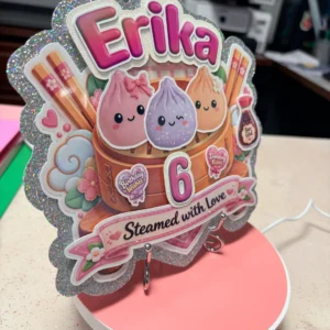 Side view of layered Kawaii Dumplings birthday cake topper with holographic glitter details